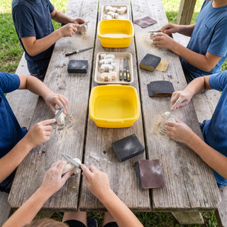 Kits by the Case (48 / 480) - kids carving soapstone at summer camp