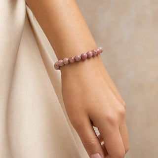 Rhodonite bead bracelet worn on the wrist, close-up