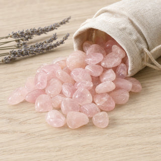 Rose Quartz Tumbled Stones A Quality - Brazil spilling from a linen pouch