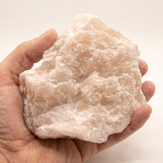 Pink Soapstone Rough (per lb) - held in one hand for scale