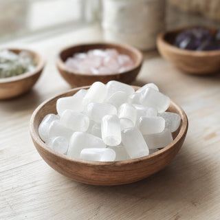 Selenite Tumbled Stones - Hand Polished in a wooden bowl on a boutique display table