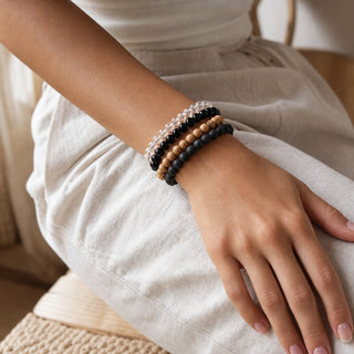 Silver Sheen Obsidian bead bracelet stacked with other bead bracelets on the wrist