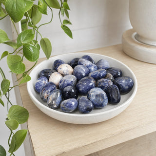 Sodalite B Tumbled Stones - India in a stoneware dish on a shop shelf