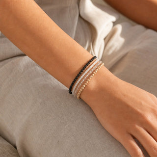 White Moonstone bead bracelet stacked with other bead bracelets on the wrist