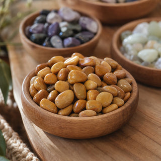 Yellow Jasper Tumbled Stones - India in a wooden bowl on a boutique display table