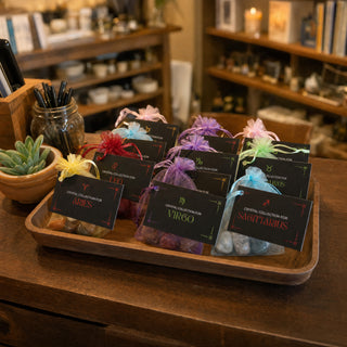Zodiac Crystal Collection kits on a wooden tray at a gift shop counter